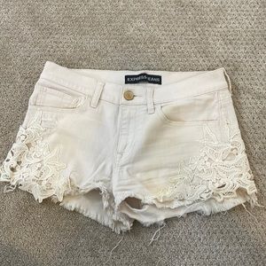 Express Ivory distressed lace side jean shorts